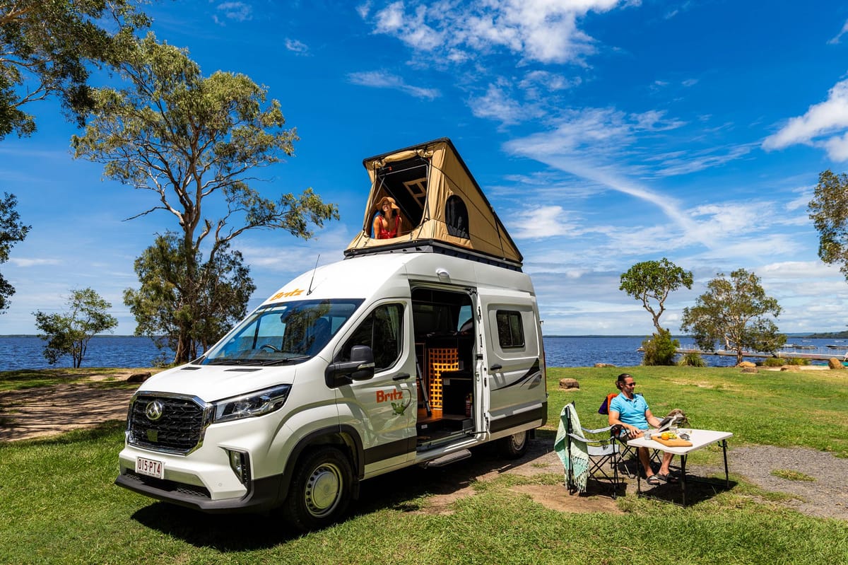 Britz Voyager campervan with pop-top roof parked by the water at Noosa, Australia